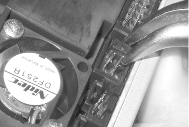 Using needlenose pliers to set the drive select jumper on the rear panel of the Plextor PlexWriter to Master