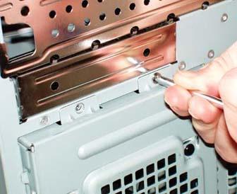 Remove the two screws that secure the removable hard drive bay to the front of the case