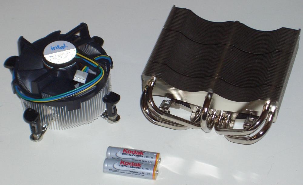 Intel stock CPU cooler (left) and Thermalright XP-120 CPU cooler, with AA batteries shown for scale