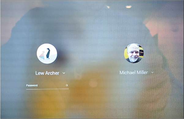 A Login Screen of a Chrome OS desktop with multi users is shown. Two user profiles with pictures and usernames are given side by side, with text field to enter Password below one of them.