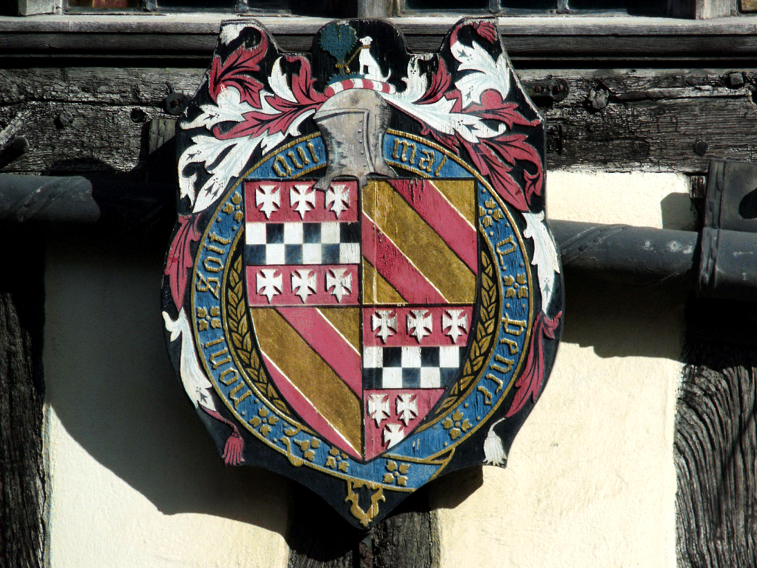 A photograph of a shield with heraldry symbols.