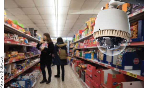 Photo illustration of a CCTV camera inside a supermarket monitoring the shoppers.