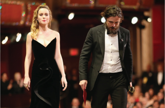 Photo of Casey Affleck walking away after winning the Oscar along with Brie Larson.