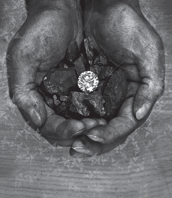 Photograph depicts two human hands holding a diamond and coal.