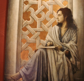 Photo of Lubna of Cordoba facing to her right while holding the pen and paper on her lap.