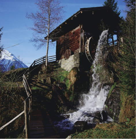 The illustration shows an image of a watermill in the Alps.