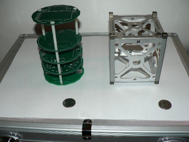 Two variants of a picosatellite, with quarters shown for scale