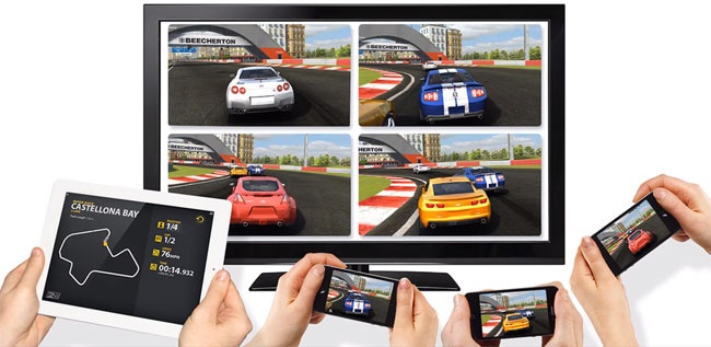 Real Racing 2—Party Play, showing a collaborative game involving an iPad 2, three iPhones, and an Apple TV (split-screen experience).