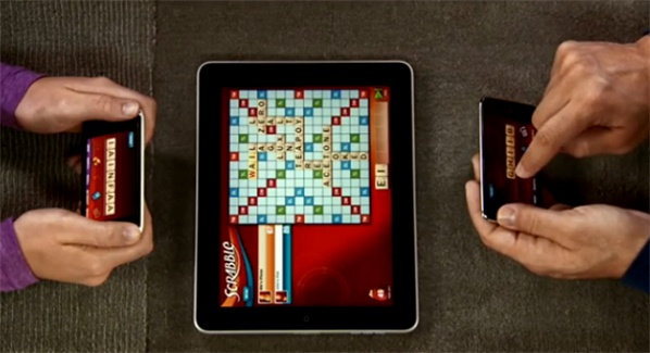 Scrabble for iPad—Party Play in action, with the iPad as the board game and the players’ iPhones holding the tiles (source: YouTube).