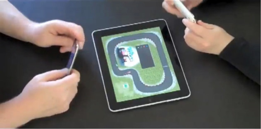 Pad Racer in action—the iPhone serves as a steering wheel for racing on the iPad track (source: YouTube).