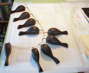 Splines were originally created using bendable wood and ``ducks,'' and were used as a draftsman's tool to fit curves. Photo courtesy of Bob Perry.