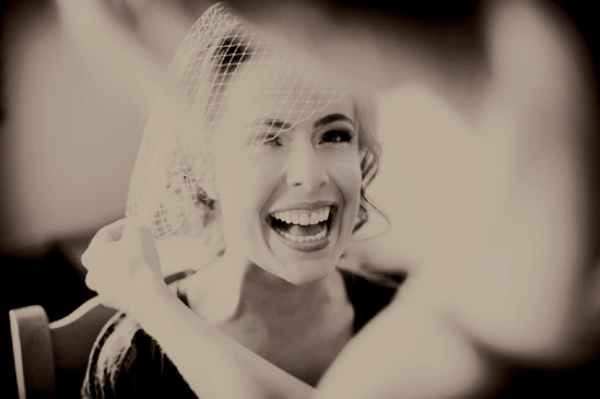As she puts on her veil, she is overcome with the excitement of the moment