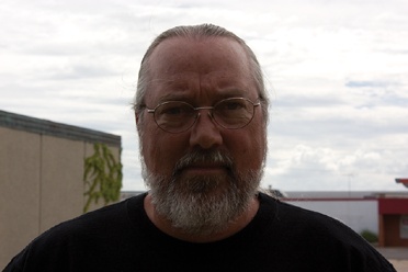 This image suffers from bad backlighting, which is leaving the subject’s face in shadow.