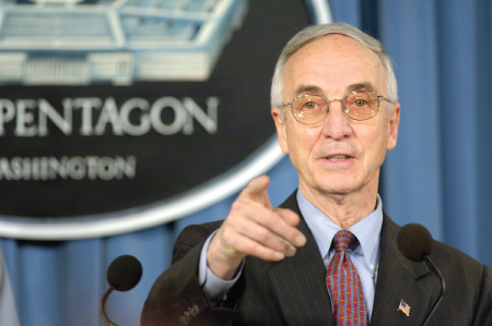Photo of Gordon R. England speaking in front of pentagon.
