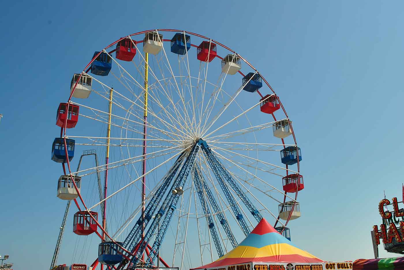 Photo of ferris wheel against blue sky