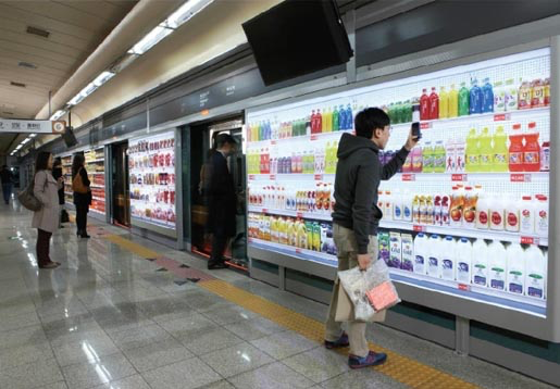 Commuter shopping Home Plus’s virtual supermarket shelves (image: http://theinspirationroom.com/daily/2011/homeplus-virtual-subway-store)