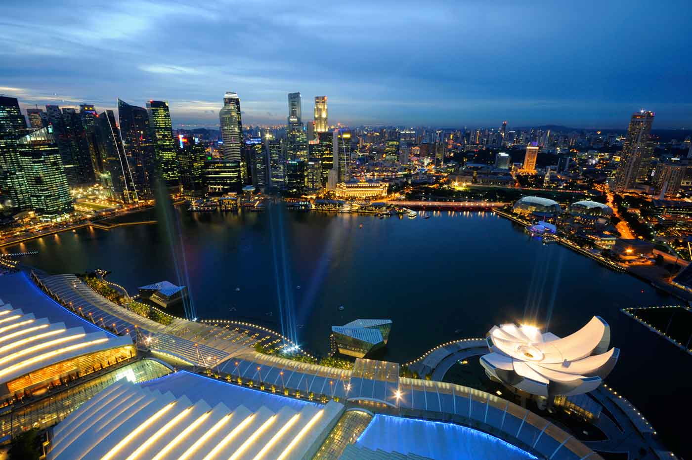 Marina Bay and the skyline of the Central Business District of Singapore at dusk, by William Cho.
