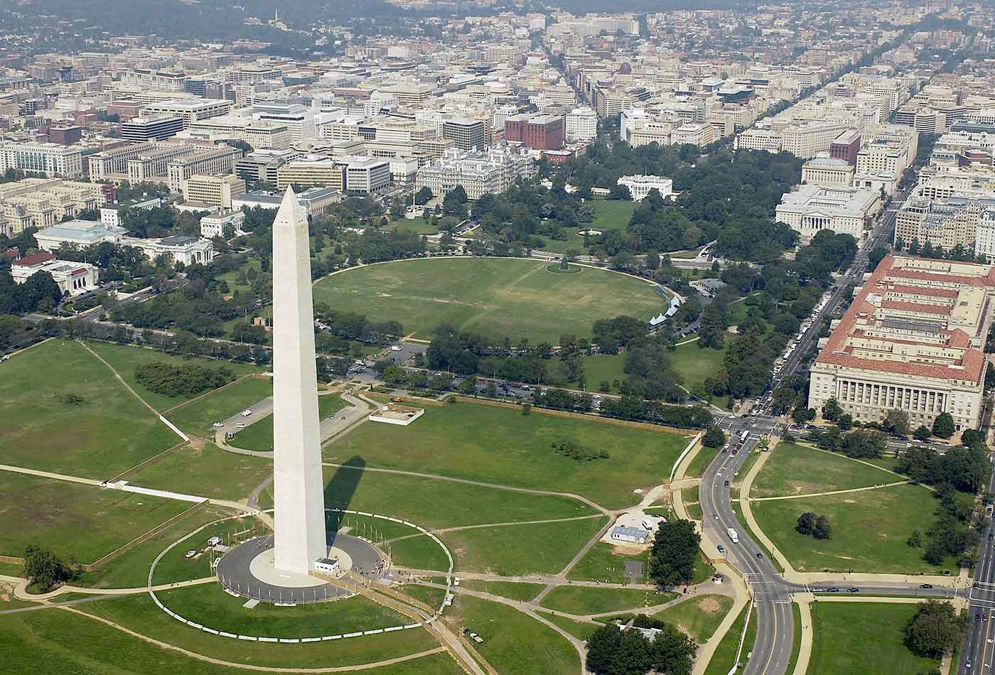Aerial view of the Washington Monument with the White House in the background.